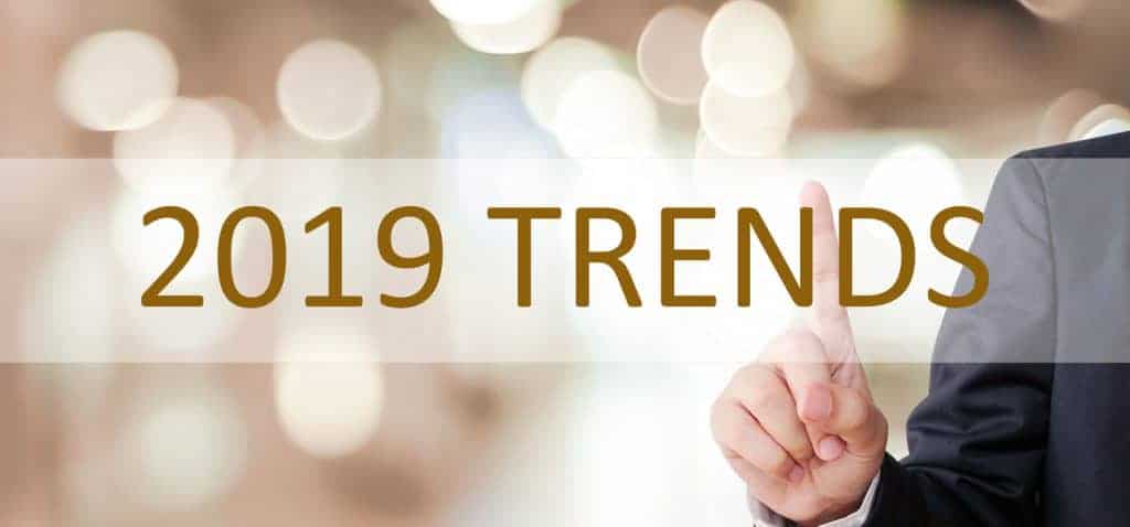 Businessman hand touching 2019 trend over blur office background, banner, 2019 business strategy annual plan, success in business concept